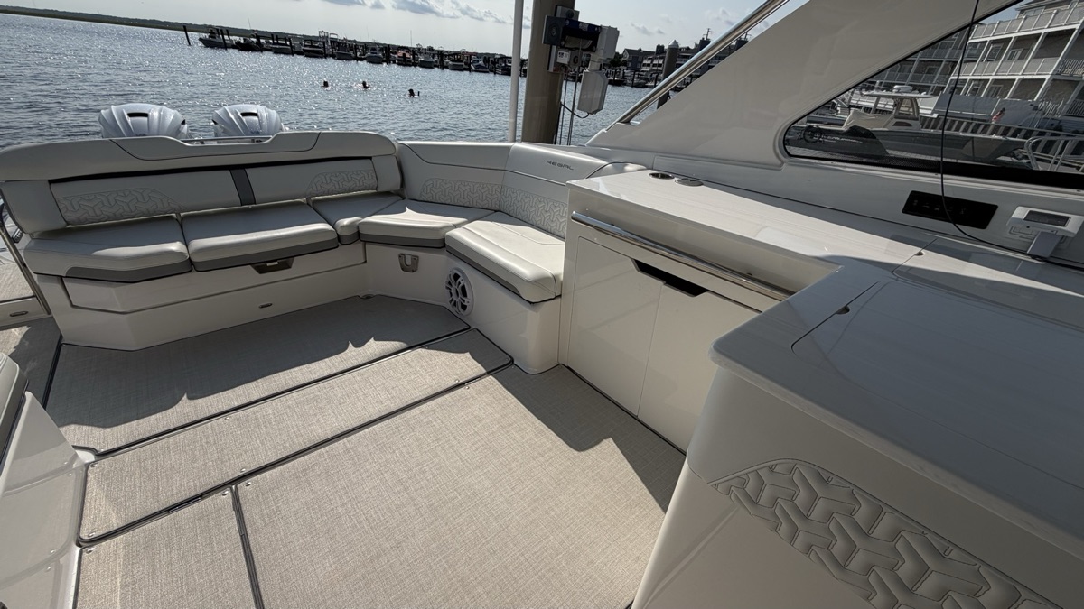 The aft cockpit of a Regal, seating and deck wiped down, the bay behind it.