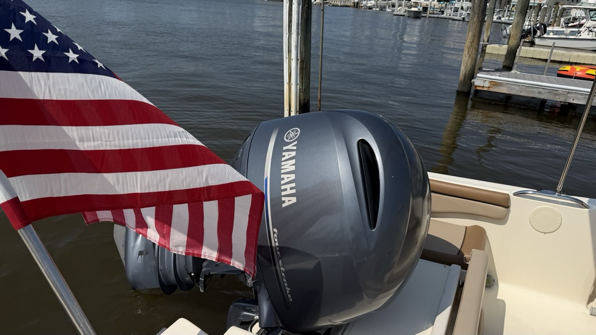 Twin outboards and transom cleaned down at the dock.